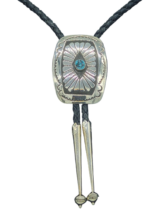 Navajo sterling silver concho bolo tie with hand-stamped sunburst design and turquoise center stone